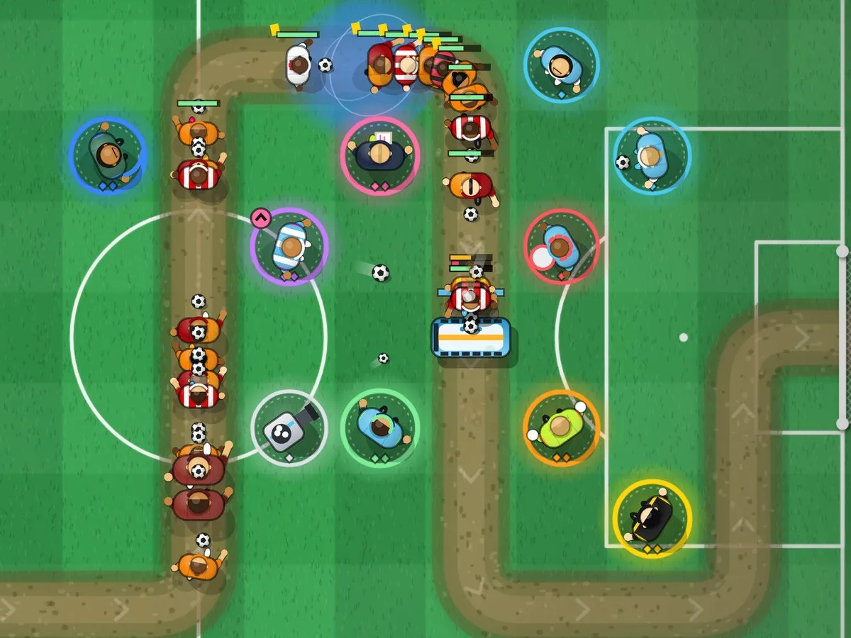 Park the Bus gameplay: defenders in coloured rings guard a winding channel on a green pitch while attackers run towards the goal.