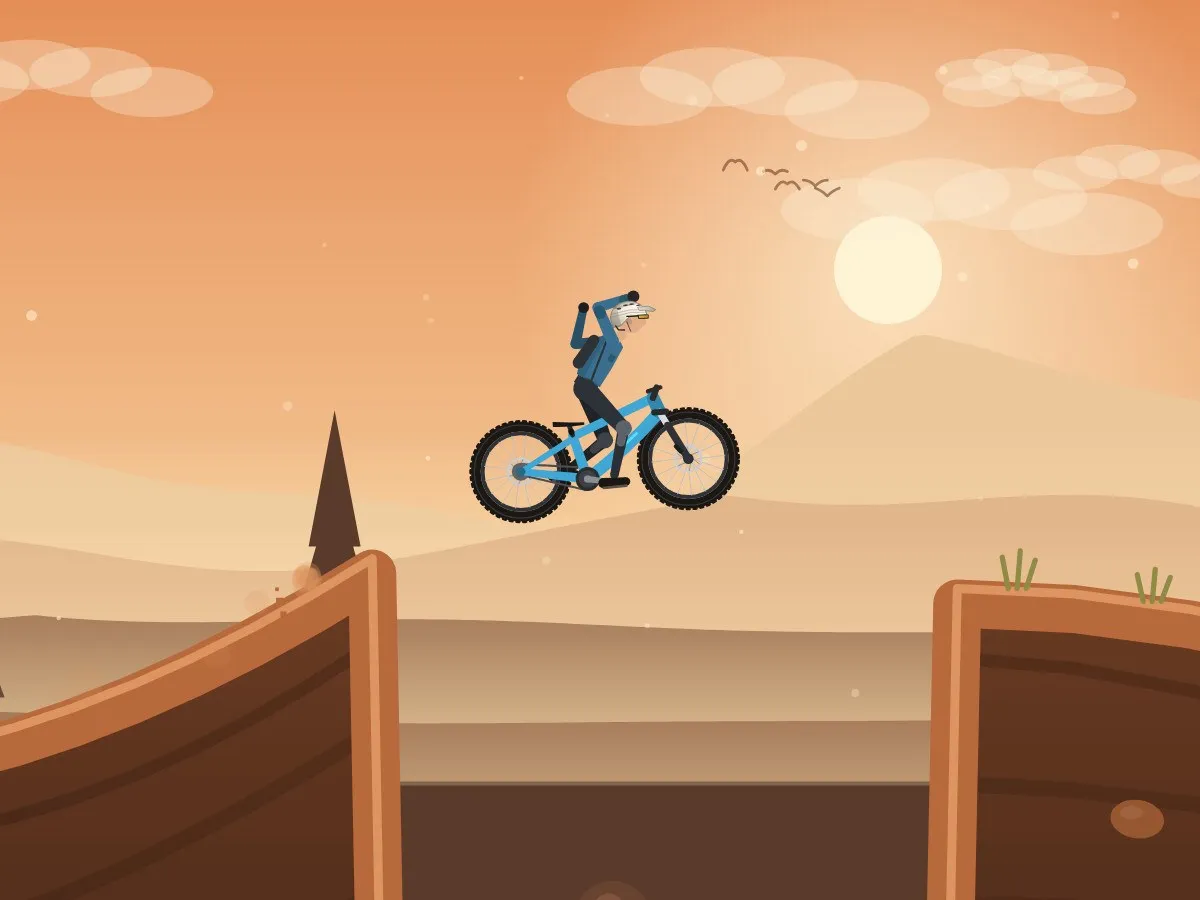 Singletrack Trials gameplay: a rider takes both hands off the bars while jumping a gap on a sunset trail.